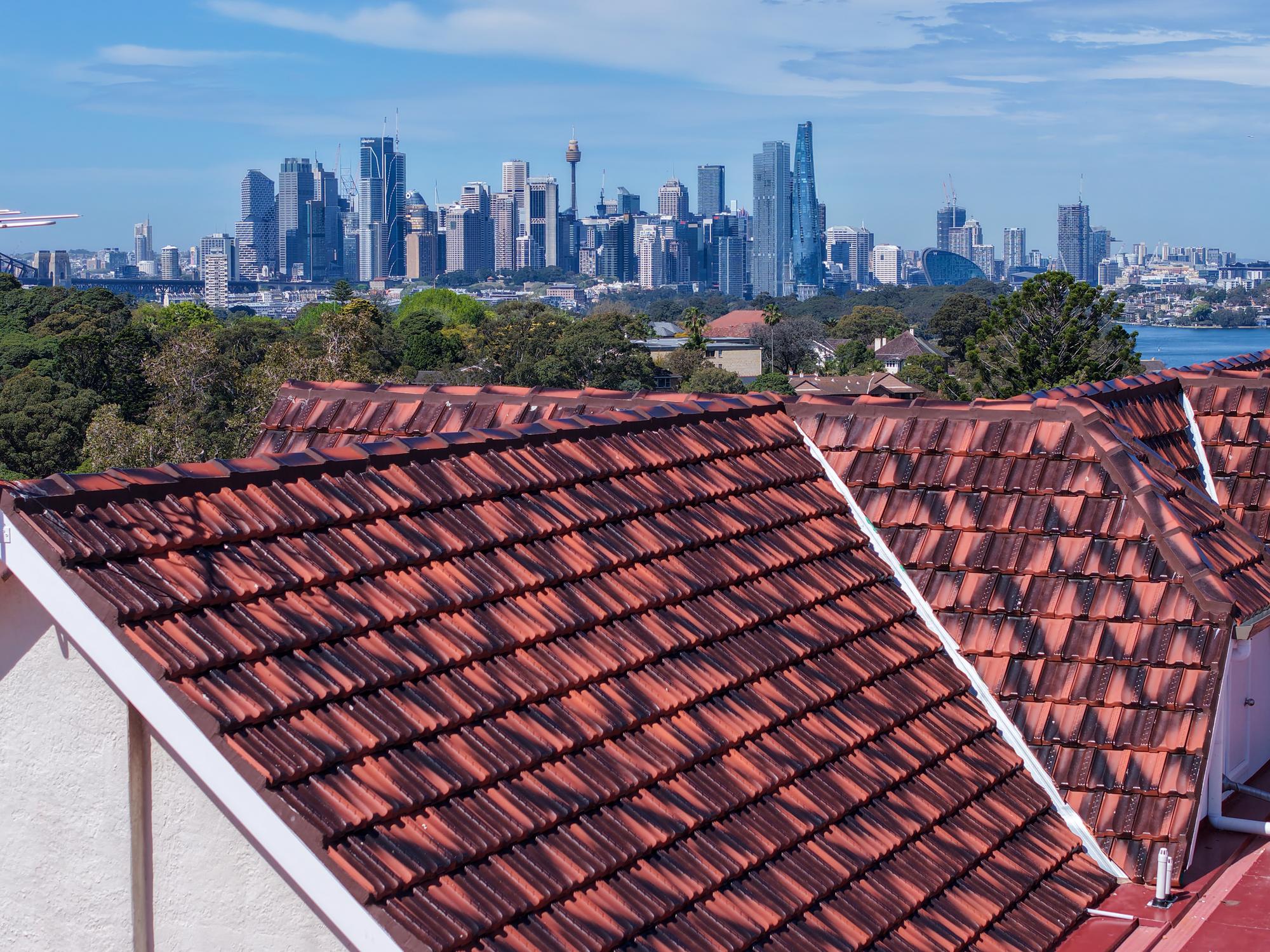 Tiled roof restored by ADKO with the Sydney CBD and harbour behind