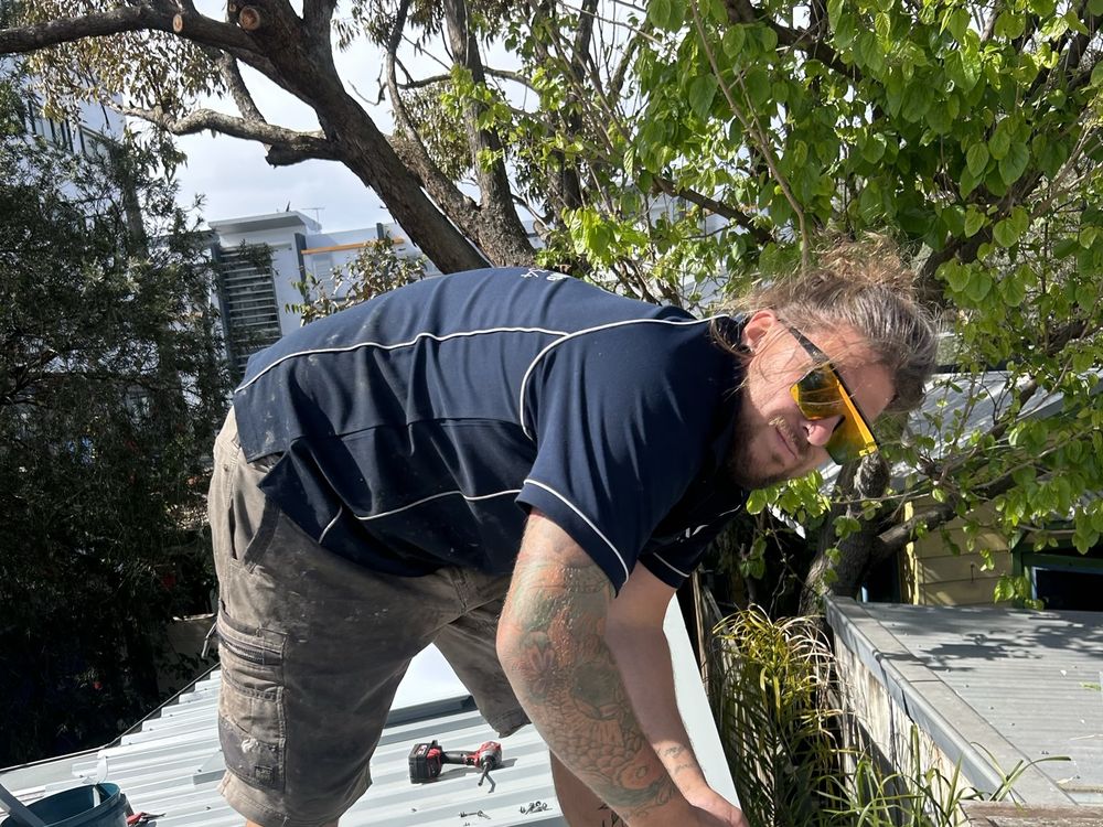 ADKO roofer cutting new flashing for a box gutter