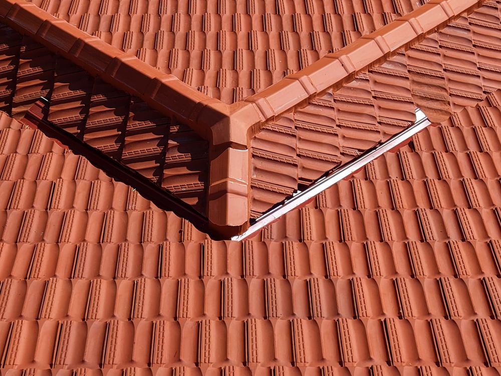 Restored terracotta tile roof ridge and valley