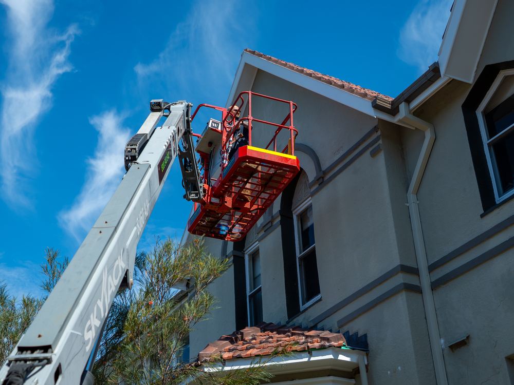 ADKO roofers working from an elevated platform on a Sydney home
