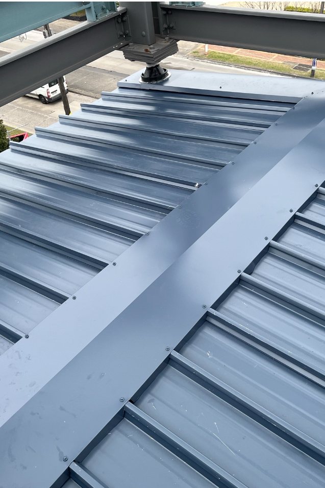 New grey metal roof with ridge capping installed by ADKO