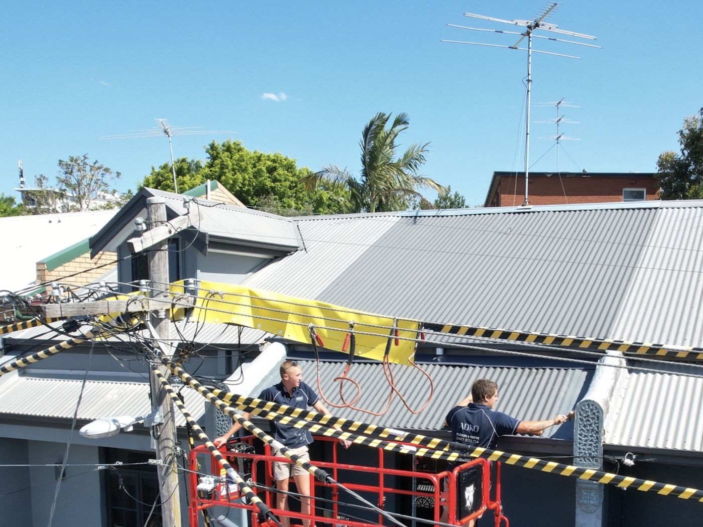 ADKO roofers on an elevated platform at a terrace roof