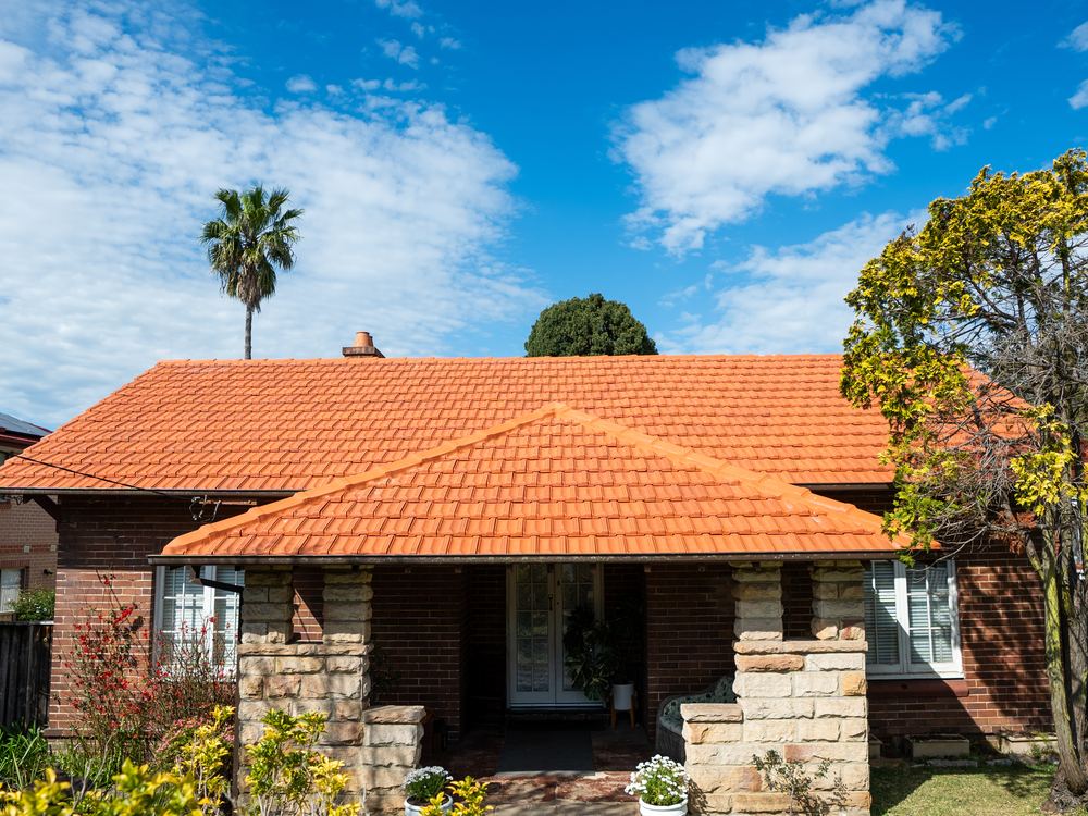 Restored terracotta tile roof on a brick bungalow